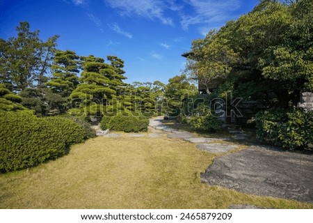 Collaboration scene of stepping stones and Japanese garden surrounded by silence in the blue sky background
