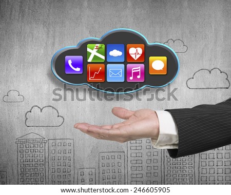 Man hand showing black cloud with colorful app icons on doodles wall background