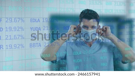 Image of trading board over caucasian male doctor wearing mask at hospital. Digital composite, multiple exposure, stock market, investment, protection, covid, medical and healthcare concept.