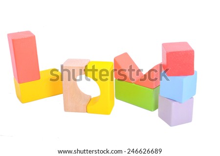 Love word made from colorful wooden block on white background