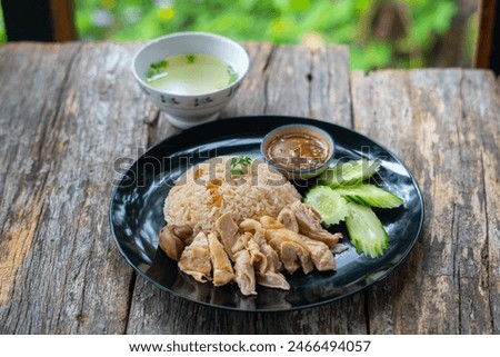 Steamed rice and chicken, served with soup and various sauce.