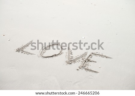 Words of love on sand. Beach background. 