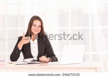 Business woman working on laptop computer at office. Modern business woman in the office with copy space. Portrait of businesswoman with laptop writes on a document at office. Office worker of laptop