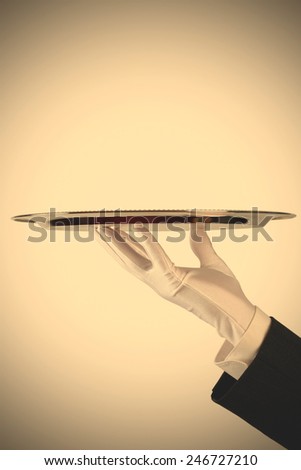 hand of the waiter in white glove with silver dish on white background with copy-space, instagram image style