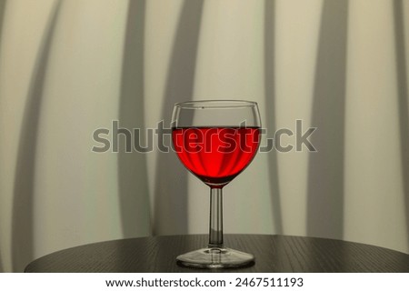 One glass of dry red wine on an elegant gray background