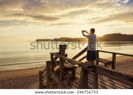 Taking photos of a beautiful sunset with a smartphone 