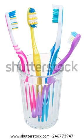 four tooth brushes in glass - family set of toothbrushes isolated on white background