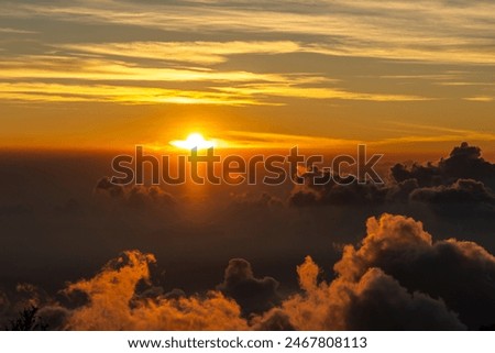Impressive sunset view of the sunset seen from the Irazu Volcano, its crater  over the clouds and the Turrialba Volcano national park seen in the Bach in Costa Rica