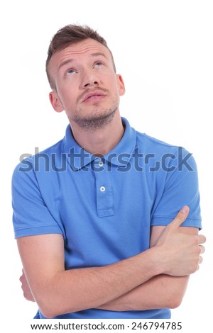 picture of a young casual man looking up with his hands folded. isolated on a white background