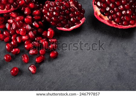 pomegranate seeds  over black background Royalty-Free Stock Photo #246797857
