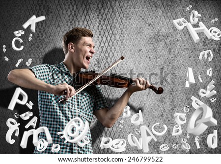 Young man in casual on cement background playing violin