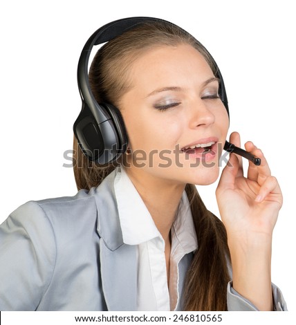 Businesswoman in headset, with her fingers on microphone boom, her mouth open, her eyes closed. Isolated over white background