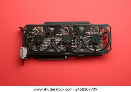 One graphics card on red background, top view