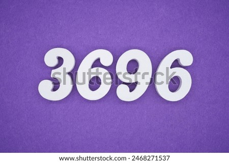 The numbers are made of white paint wood, placed on the background as a purple paper.