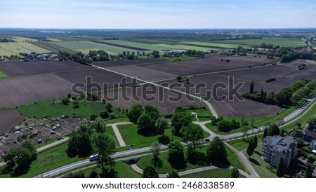 Aerial drone photo showcasing vibrant agricultural meadow fields, green pastures. Perfect for farming, crop management, and rural landscapes. Location: De Kamp in Steenwijk, Overijssel, Netherlands.