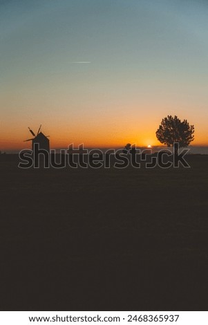 silhouette of a windmill with sunset