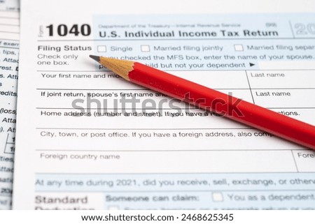 Tax Return form 1040 with pencil, U.S. Individual Income.