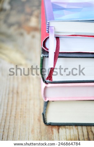 Pile of books on wooden desk