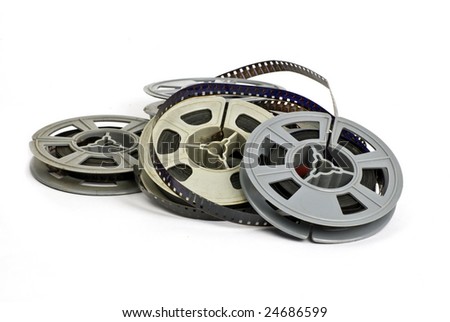 still life of random group of dirty, old 8mm cine film and reels; isolated on white ground