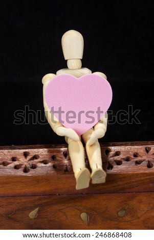 Wooden model with pink heart