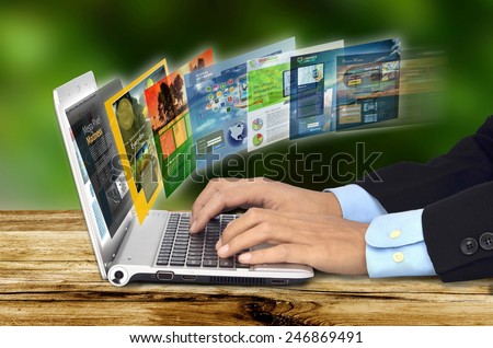 Businessman hand browsing internet websites on his laptop