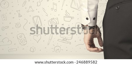 Businessman from the back in front of an social media icon wall 