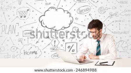 Businessman sitting at white table with hand drawn business concept background