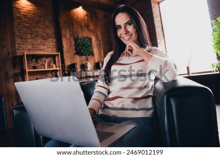 Photo of shiny pretty lady dressed striped pullover writing emails modern device indoors house room