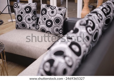close-up photo of a corner sofa with a round pillow motif