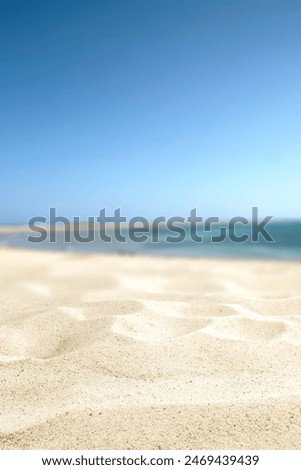 Summer background of warm sand and landscape of sea with blue sky. 