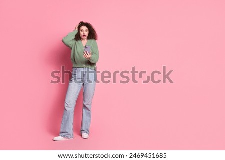 Photo of lovely cute shocked woman wear stylish khaki clothes read news empty space isolated on pink color background