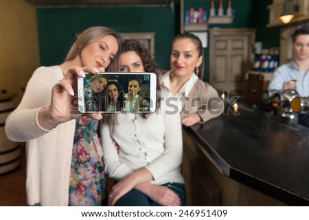 Group of friends taking selfie.