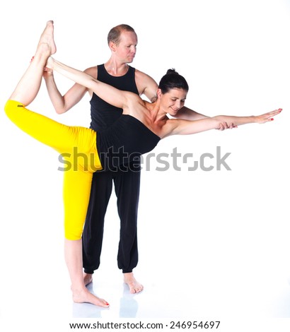 Young couple doing yoga. Isolated on white backgraund