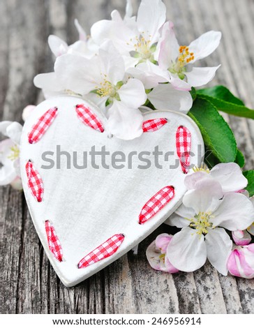 Spring Blossom and heart over wooden background