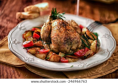 Cockerel baked with potatoes and tomatoes Royalty-Free Stock Photo #246966763