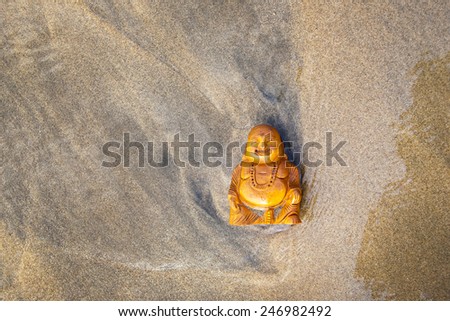 Budda statuette on the beach. 