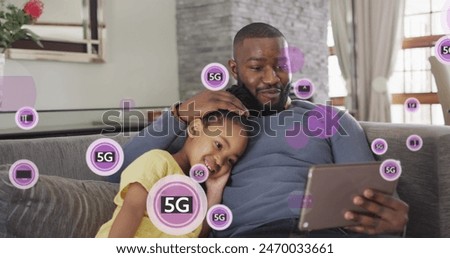 Image of 5g text over african american man and his daughter using tablet. Global social media and digital interface concept digitally generated image.