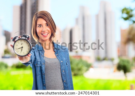young cool woman with alarm clock