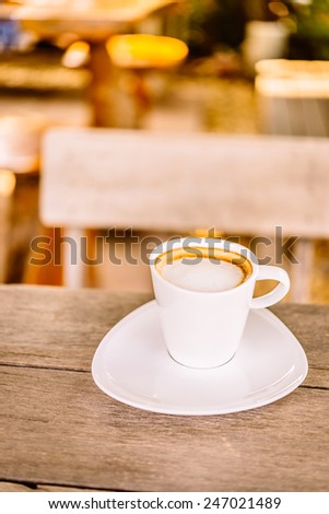 Latte coffee cup in white mug on wooden table - vintage effect style pictures