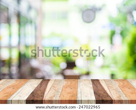 Empty tropical wood table and blurred garden cafe light background. product display template.Business presentation Royalty-Free Stock Photo #247022965