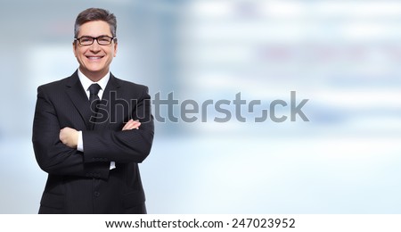 Executive smiling businessman over blue banner background