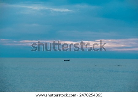 fishermen looking for fish in the middle of the sea with traditional canoes in a beautiful afternoon