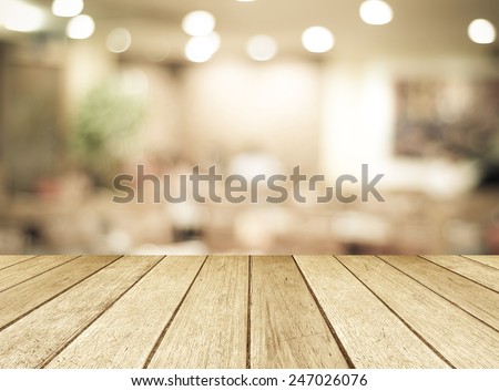 Wood table background, Shelf at cafe shop,  Perspective wood over blur cafe with bokeh light background, Table for product display, Empty wooden counter in blur white room for mockup, banner, template Royalty-Free Stock Photo #247026076