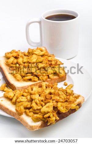 scrambled eggs on toasts and coffee breakfast
