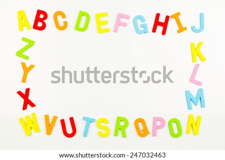 Frame of Colorful alphabet magnets on a whiteboard