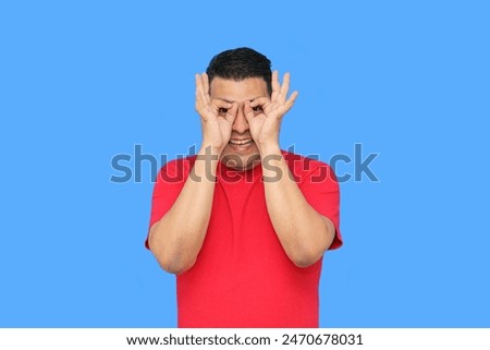 Dark-skinned latin adult man makes the ok sign with his fingers showing positive and happy