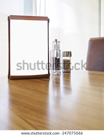 Mockup Menu frame on Table in restaurant cafe shop with Clipping path for edit