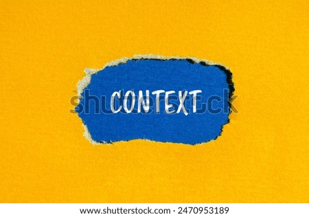 Context word written on ripped yellow paper with blue background. Conceptual context symbol. Copy space.
