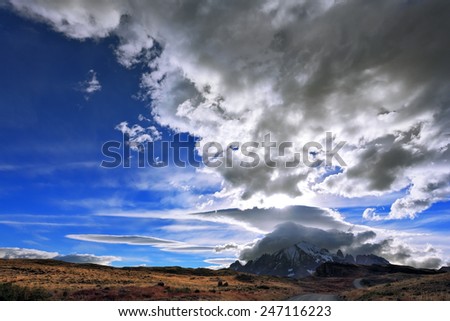 The Chile National Park "Torres del Paine". Incredible shaped cloud formed by glaciers glisten in the sun. On the horizon are seen mountains with snow-capped peaks. Picture taken with a fisheye lens