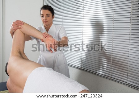 man is getting back massage from a physiotherapist